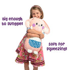 Girl hugging Bella the Bunny GlowMate by Bolderglow