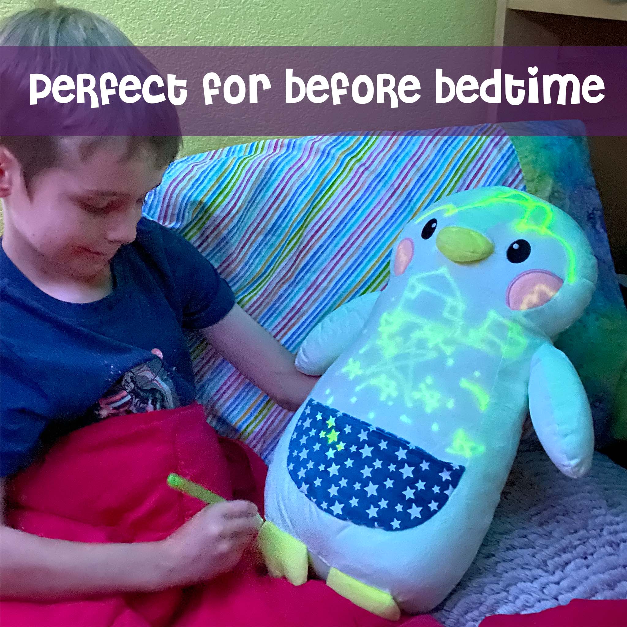Boy hugging Penny the Penguin GlowMate by Bolderglow