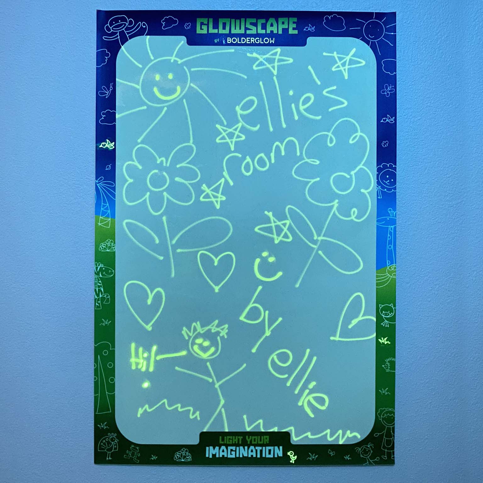 Glowscape hung on a blue wall with various doodles glowing green