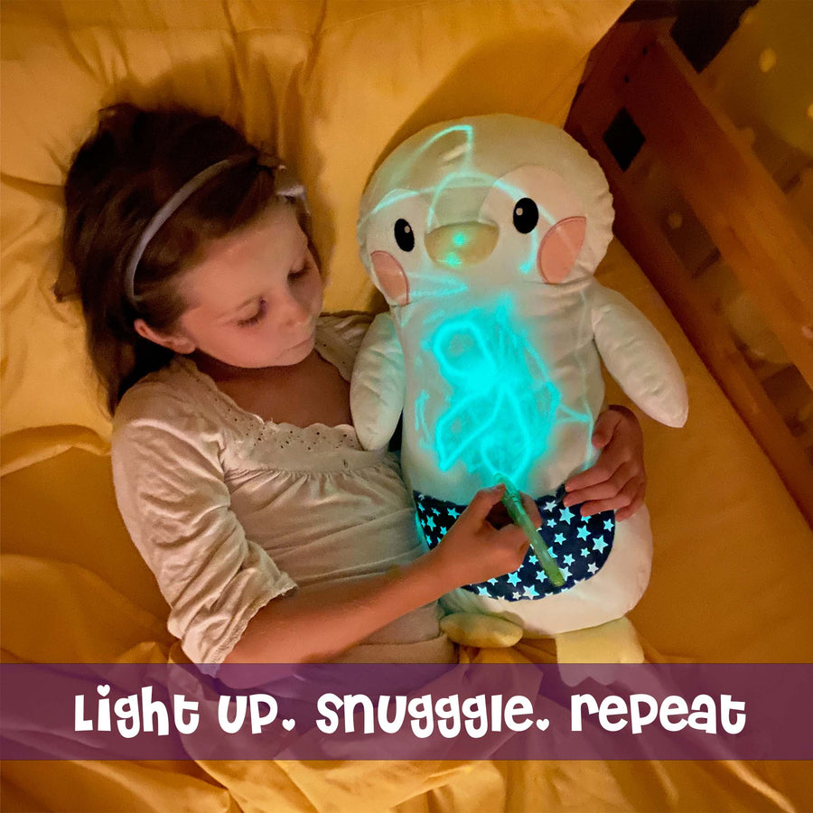 Girl hugging Penny the Penguin GlowMate by Bolderglow