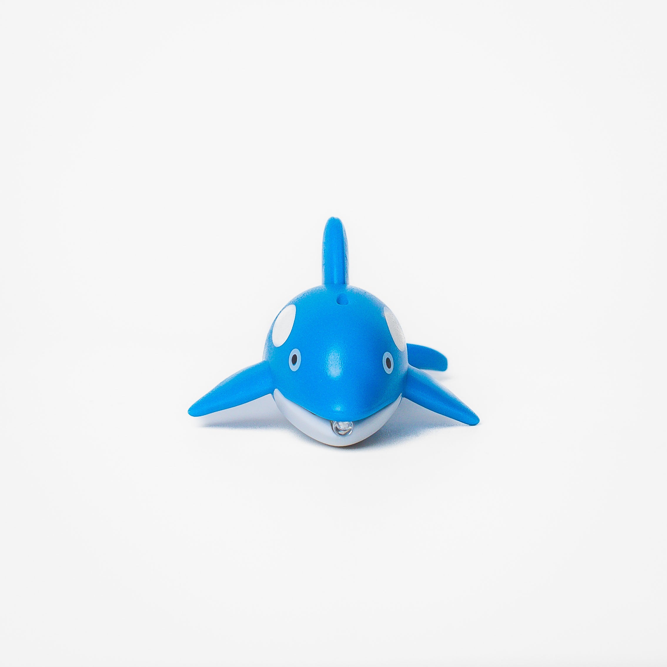 Blue whale shaped pen light with a purple LED facing front