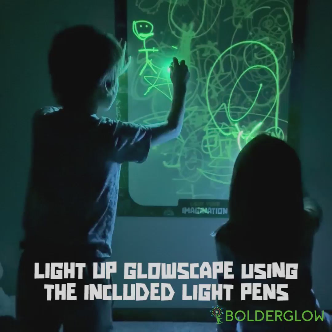 Two kids drawing on Glowscape, making shapes and doodles using light pens